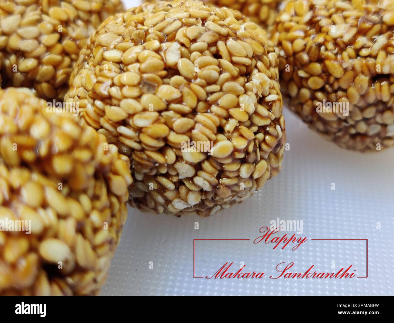 Til Gul OR Sweet Sesame Laddu for Indian festival Makar Sankranti over white background Stock Photo