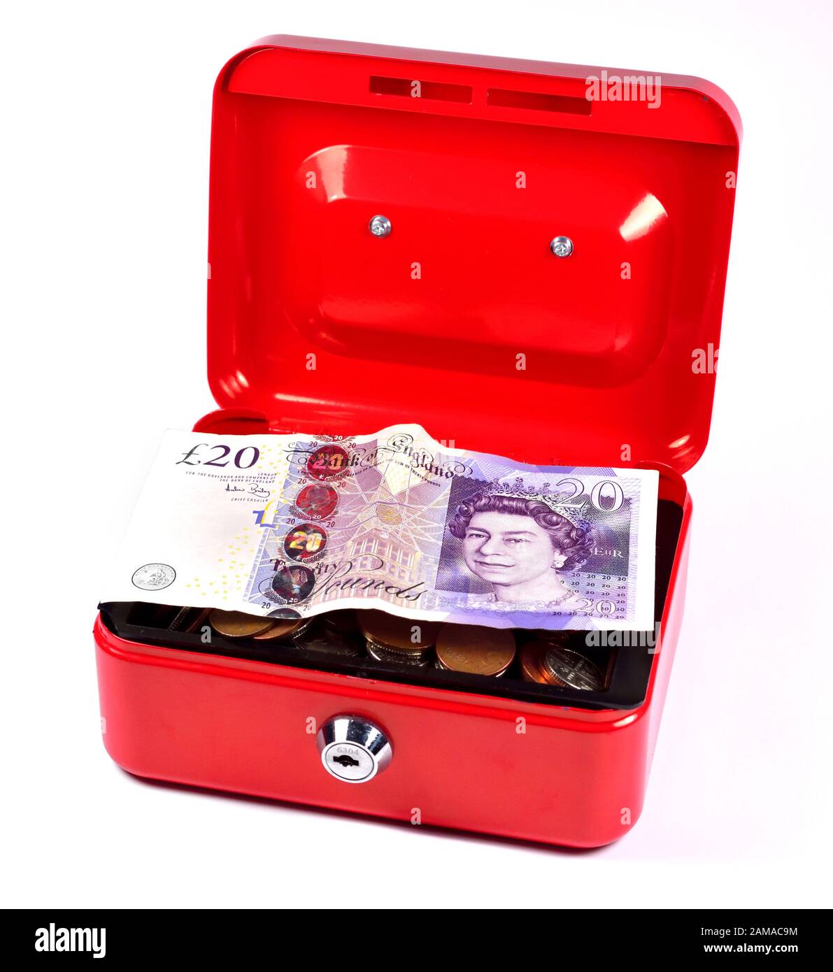 Red cash tin with coin change and a twenty pound note on a white