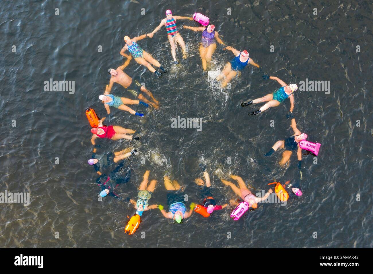Callander, Scotland, UK. 12th Jan 2020. Drone images of open water swimmers from the Fife Wild Swimmers club take advantage of the cold but sunny weather to go swimming in Loch Lubnaig in The Trossachs, Stirlingshire. Apart from their usual swim they took time to have fun and practice some synchronised swimming moves before the cold forced them from the loch.  Iain Masterton/Alamy Live News Stock Photo