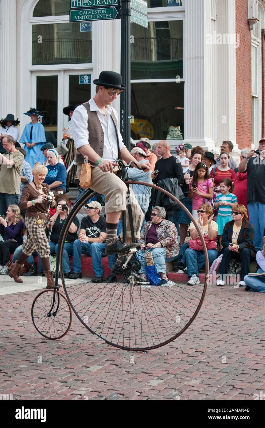 Performer on high wheel aka penny farthing cycle at Dickens on The Strand parade, The Strand, Galveston, Texas, USA Stock Photo
