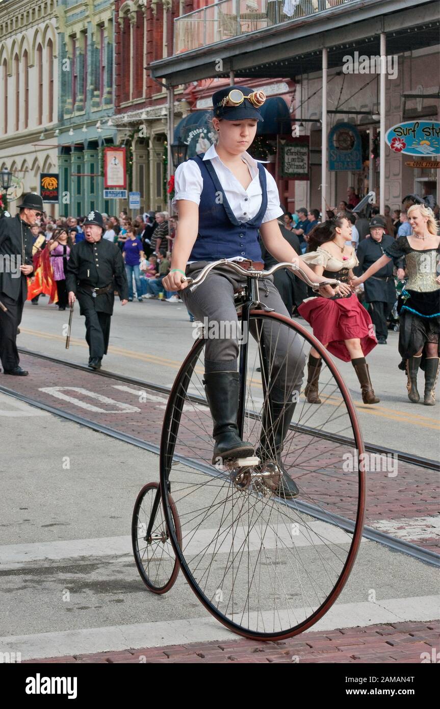Performer on high wheel aka penny farthing cycle at Dickens on The Strand parade, The Strand, Galveston, Texas, USA Stock Photo