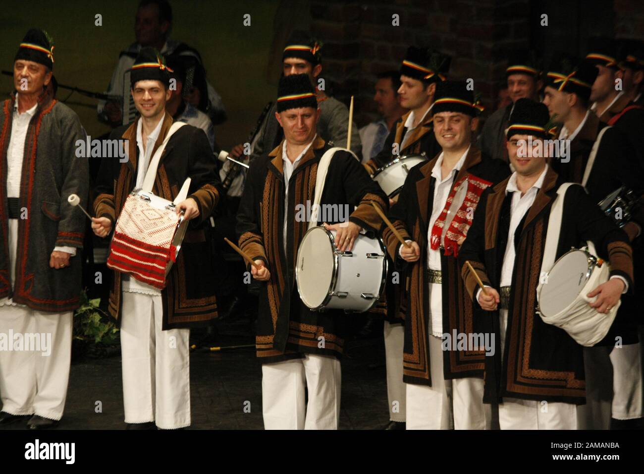 Professional dancers of the Banatul Folklore Ensemble hold hands in a traditional Romanian dance wearing traditional beautiful costumes. Stock Photo