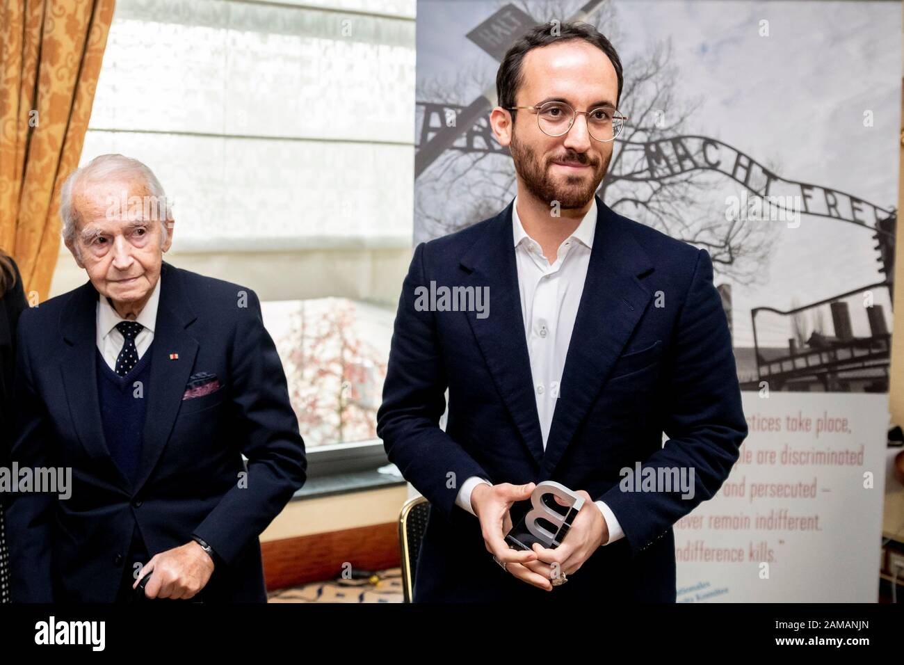 Berlin, Germany. 12th Jan 2020. Igor Levit (r), pianist, and Leon Schwarzbaum, Holocaust survivor, are standing at the Maritim Hotel Berlin when Levit is honored by the International Auschwitz Committee with the statue 'B' as 'Gift of Memory'. Levit was awarded for his commitment against anti-Semitism and right-wing extremism. The statue is modelled on the letter 'B' in the lettering 'ARBEIT MACHT FREI' above the Auschwitz gate, which the prisoners in Auschwitz had secretly turned upside down when they had to manufacture the sign for the SS. Credit: dpa picture alliance/Alamy Live News Stock Photo