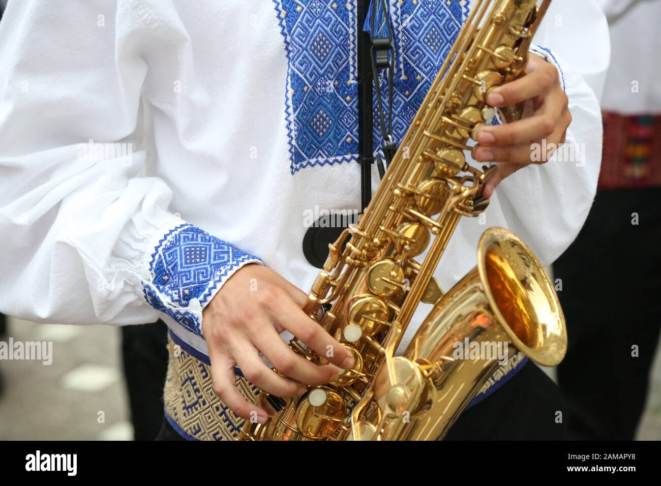 Folklore artist play saxophone wearing beautiful traditional costume.  Traditional music and ancient costumes Stock Photo - Alamy