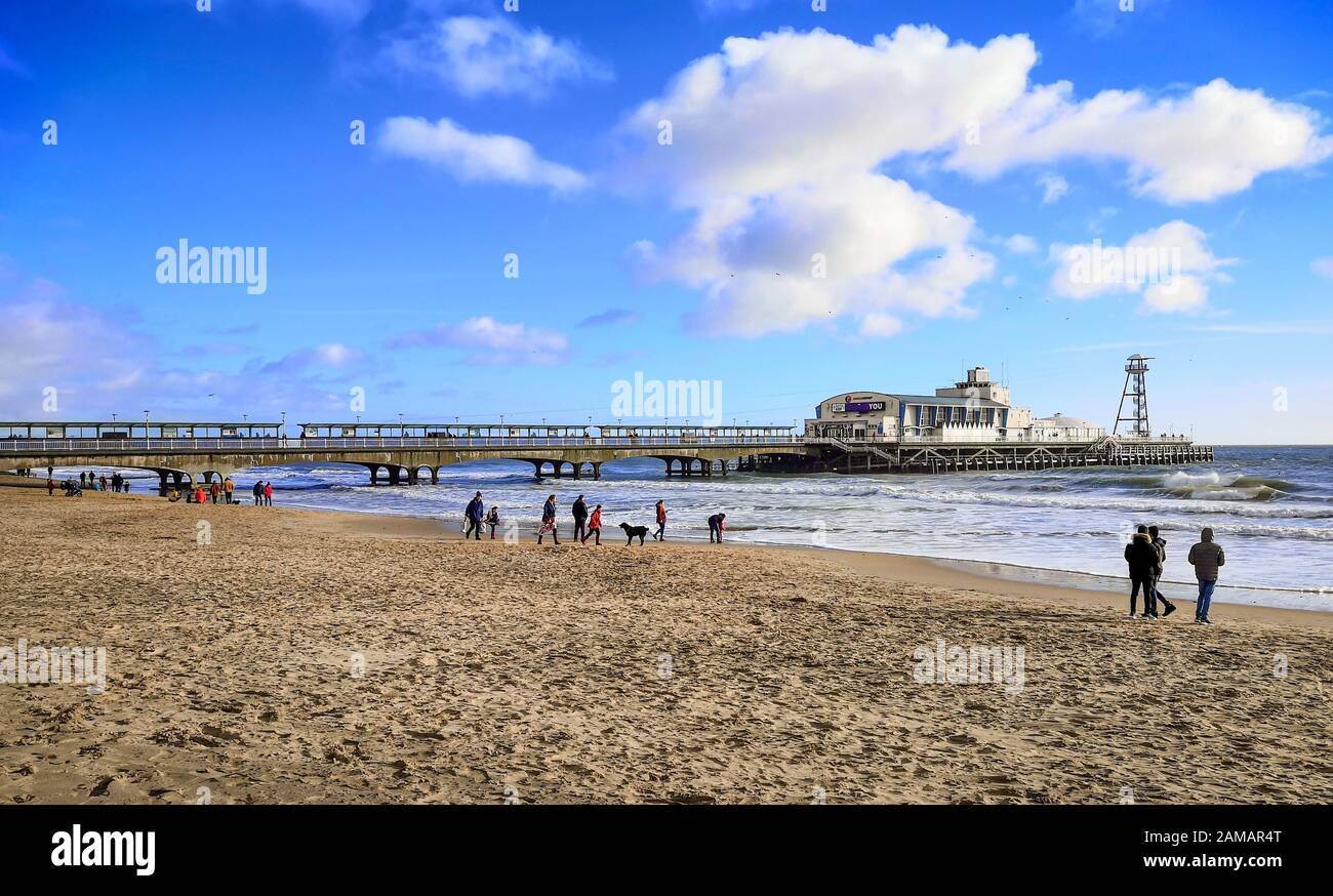 Bournemouth, UK. 12th Jan, 2020. People enjoy the winter sun with a walk on the beach in Bournemouth, Dorset. Uncommonly warm weather in the UK. Credit: Thomas Faull/Alamy Live News Stock Photo