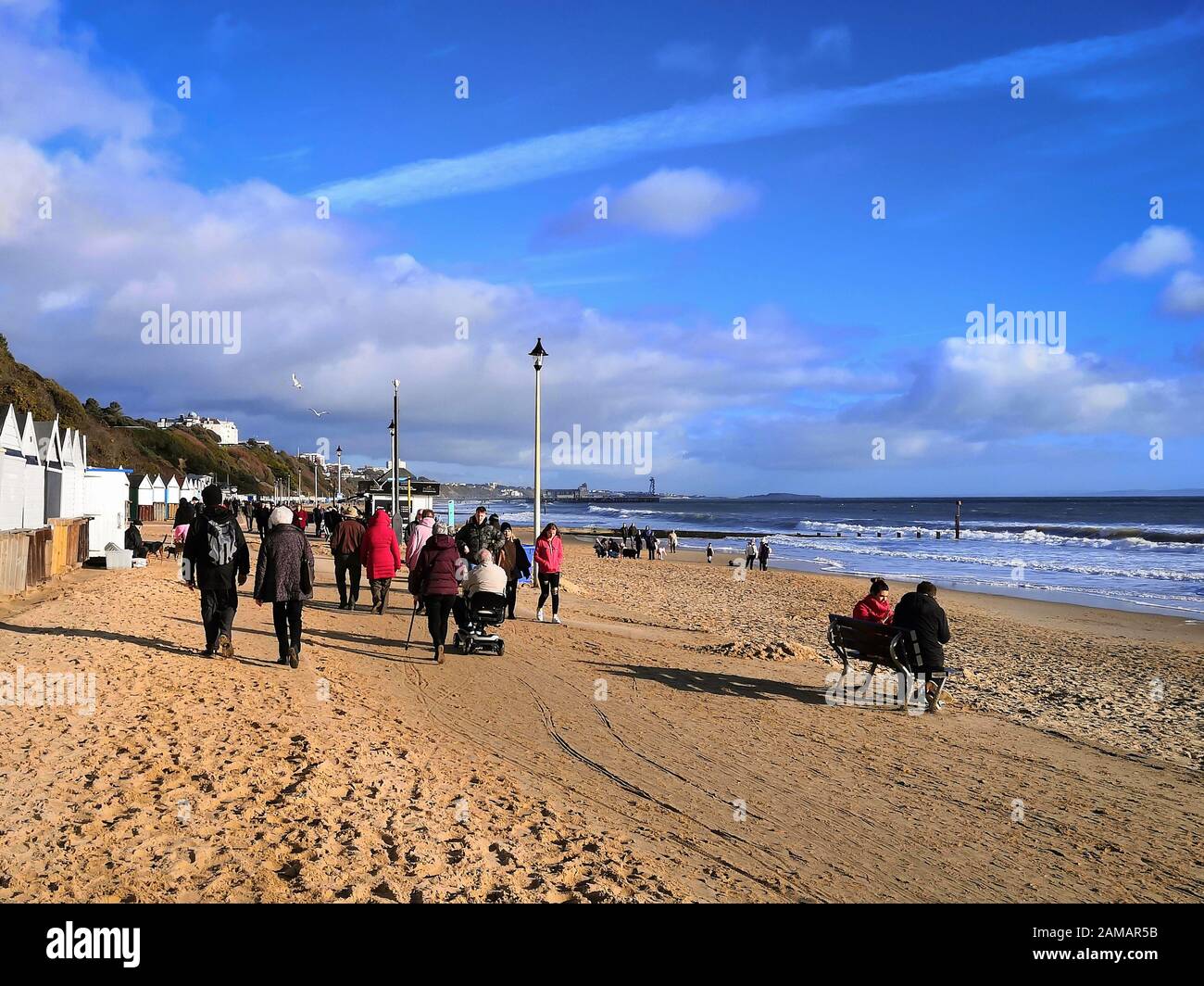 Bournemouth, UK. 12th Jan, 2020. People enjoy the winter sun with a walk on the beach in Bournemouth, Dorset. Uncommonly warm weather in the UK. Credit: Thomas Faull/Alamy Live News Stock Photo