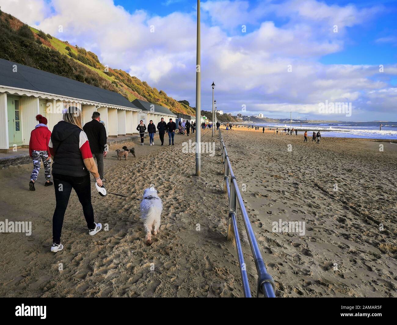 Bournemouth, UK. 12th Jan, 2020. People enjoy the winter sun with a walk on the beach in Bournemouth, Dorset. Uncommonly warm weather in the UK. Credit: Thomas Faull/Alamy Live News Stock Photo