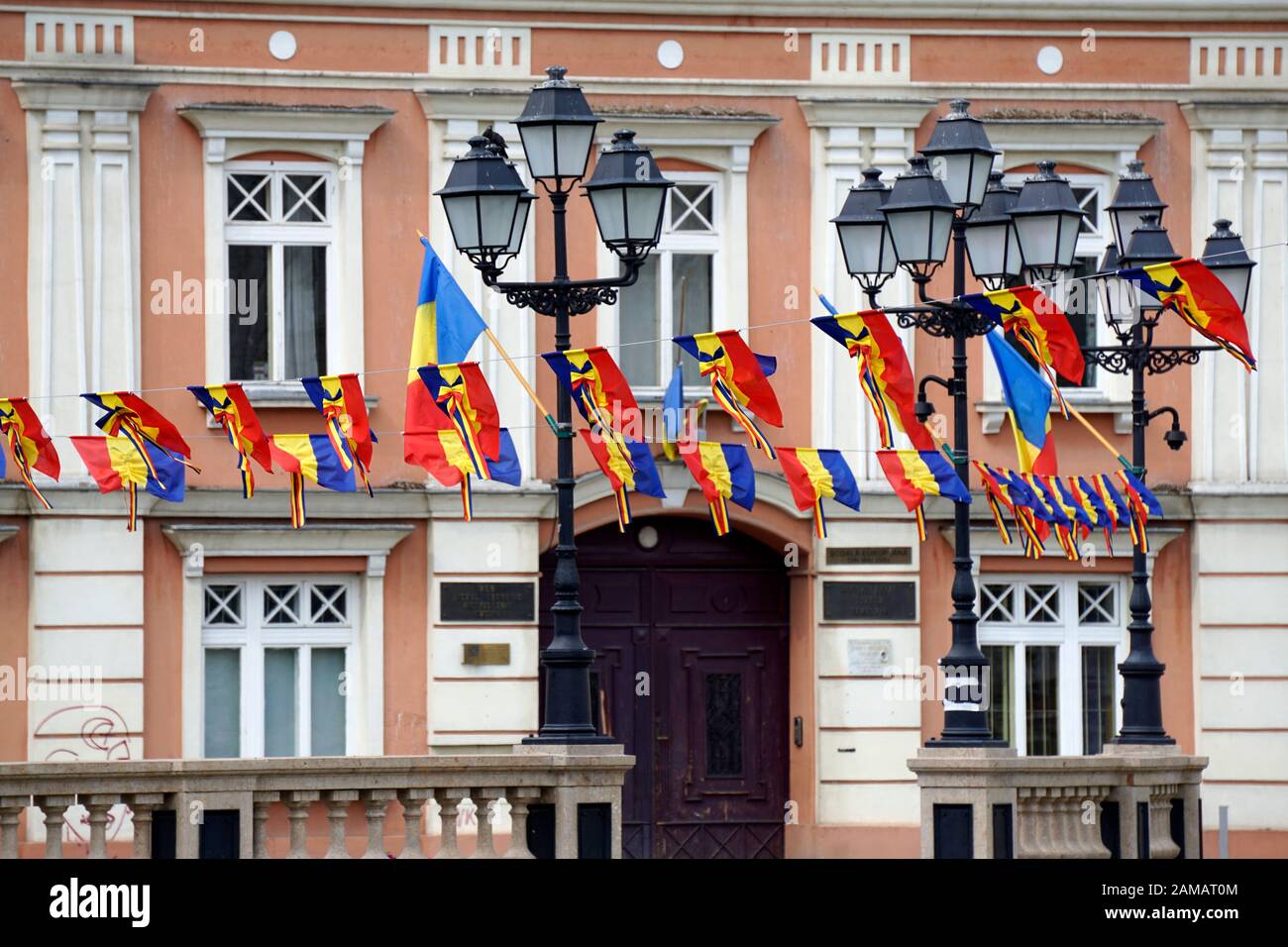 The historical center of Timisoara festively decorated with rows of  Romanian tricolor flags. Festive decorations with Romanian tricolor flags  and garl Stock Photo - Alamy