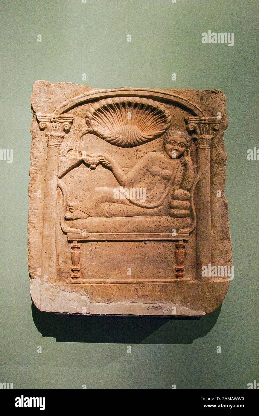 Egypt, Alexandria, National Museum, Coptic art, a tombstone, made of limestone, with a woman drinking. The upper part represents a seashell. Stock Photo