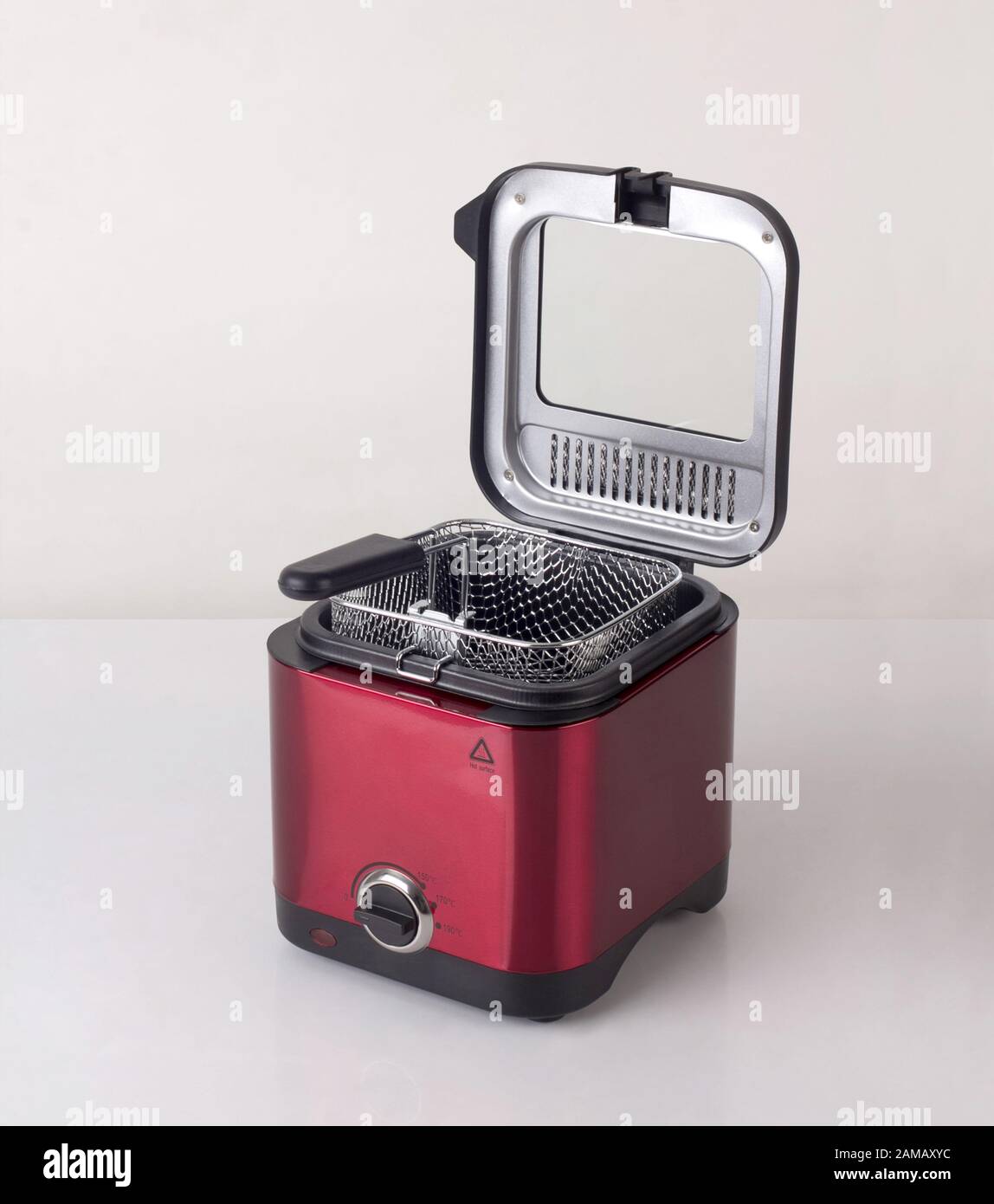 empty red deep fryer machine, modern kitchenware, isolated on white background Stock Photo