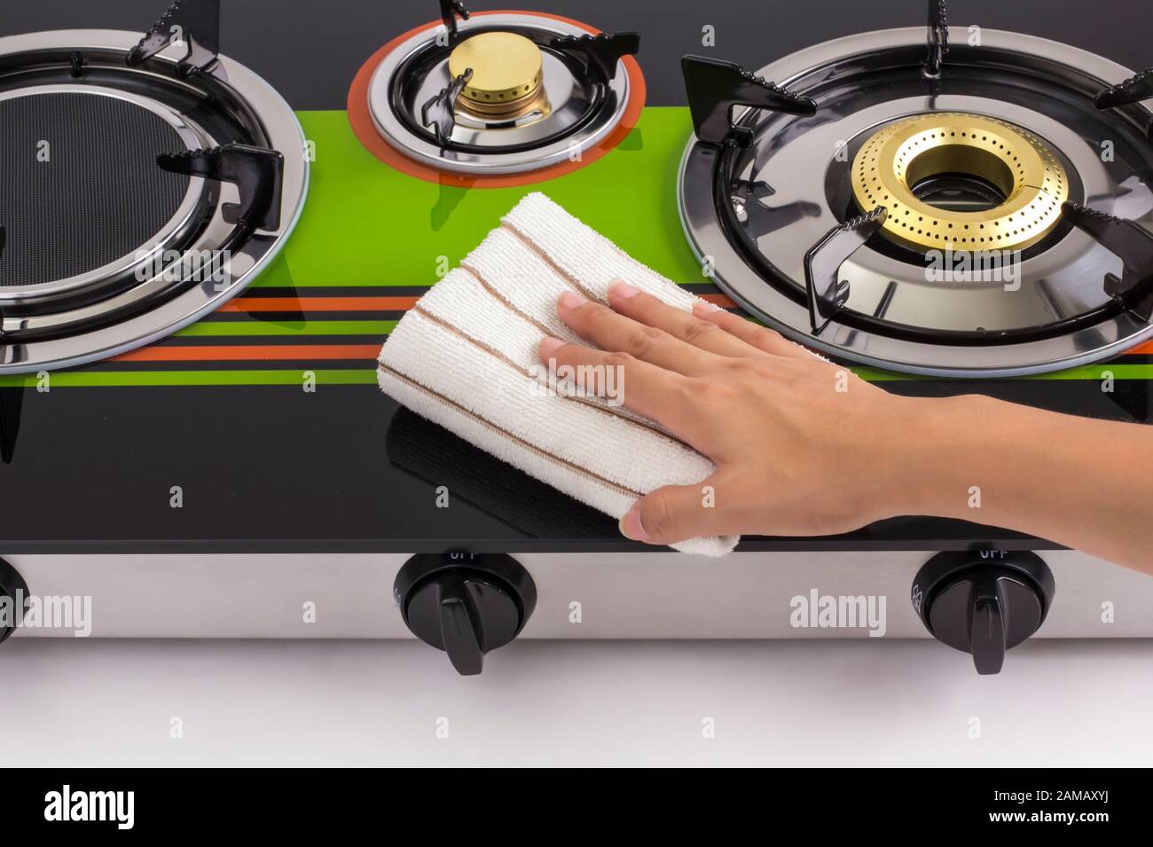 image of housewife hand cleaning gas stove Stock Photo