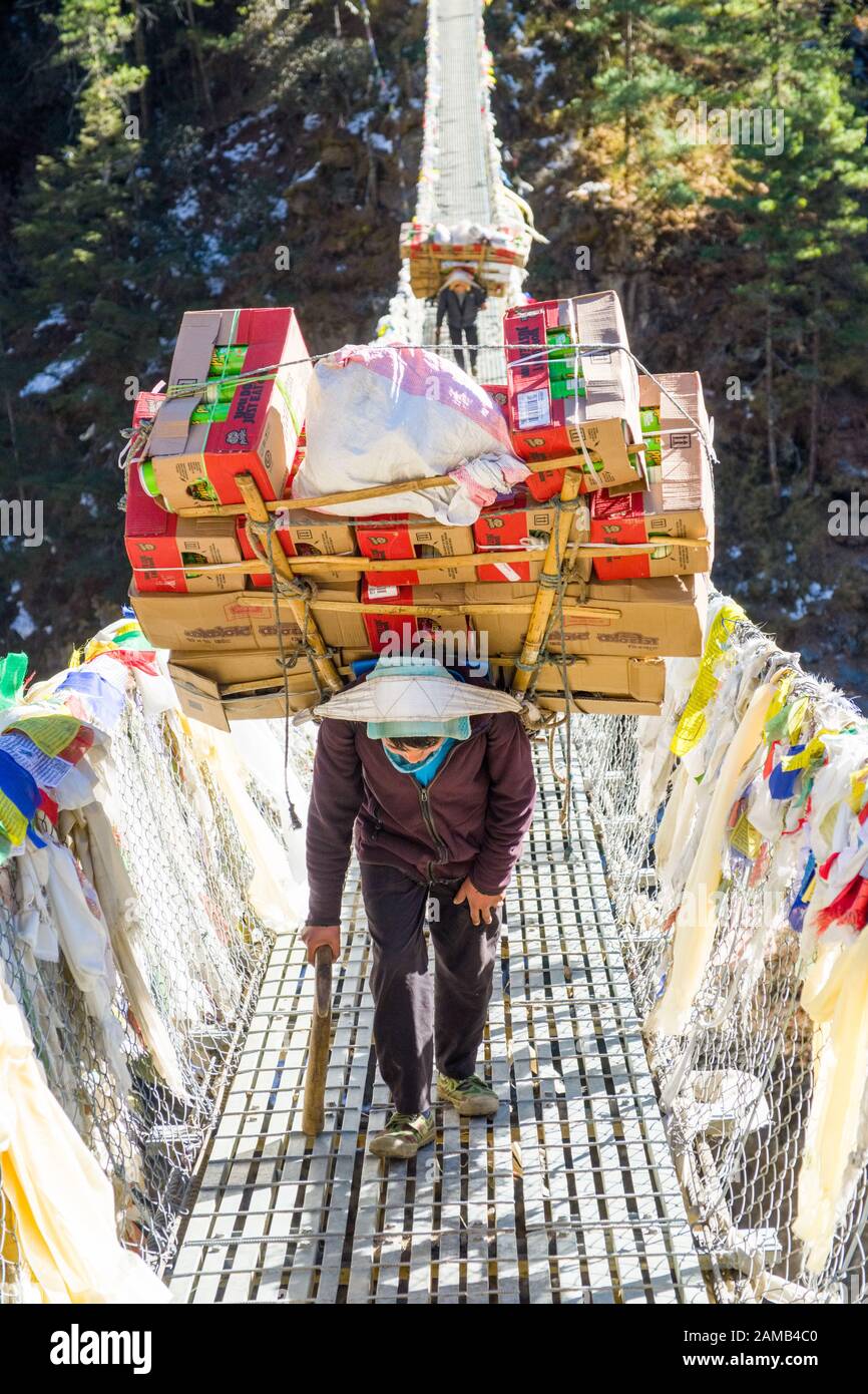 Porters laden with supplies for trekkers in the Khumbu region of Nepal Stock Photo