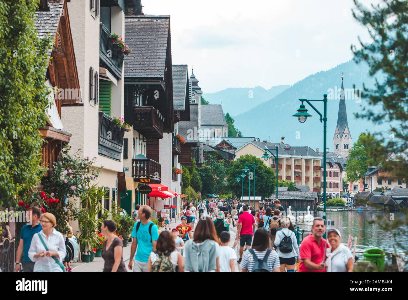 Hallstatt, Austria - June 15, 2019: people walking by city quay enjoying the view Stock Photo