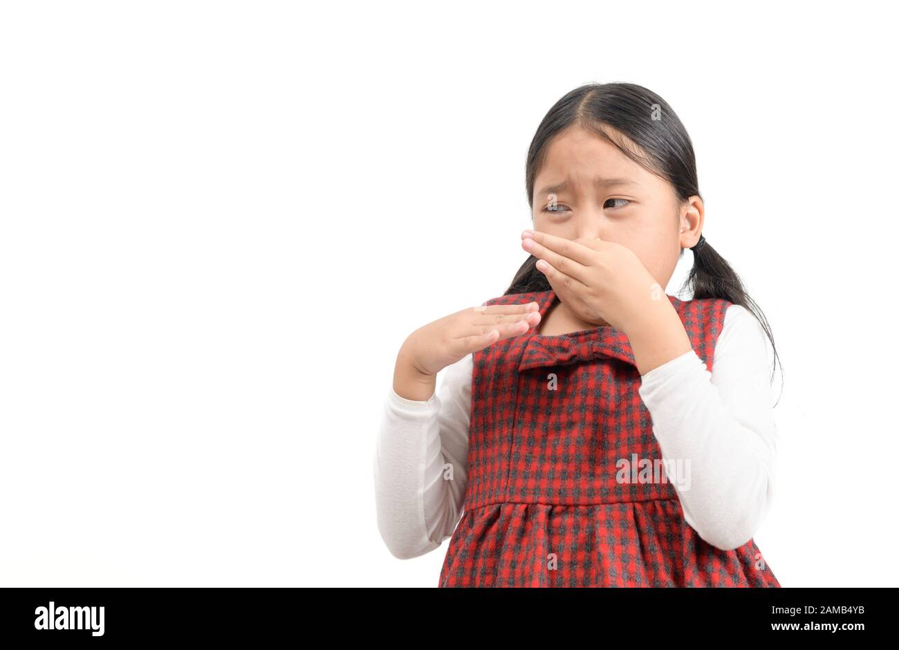 Smells bad, awful odor. cute asian girl  squeezing nose with fingers with disgust expression, eager to slip away from bad smell indoors Stock Photo
