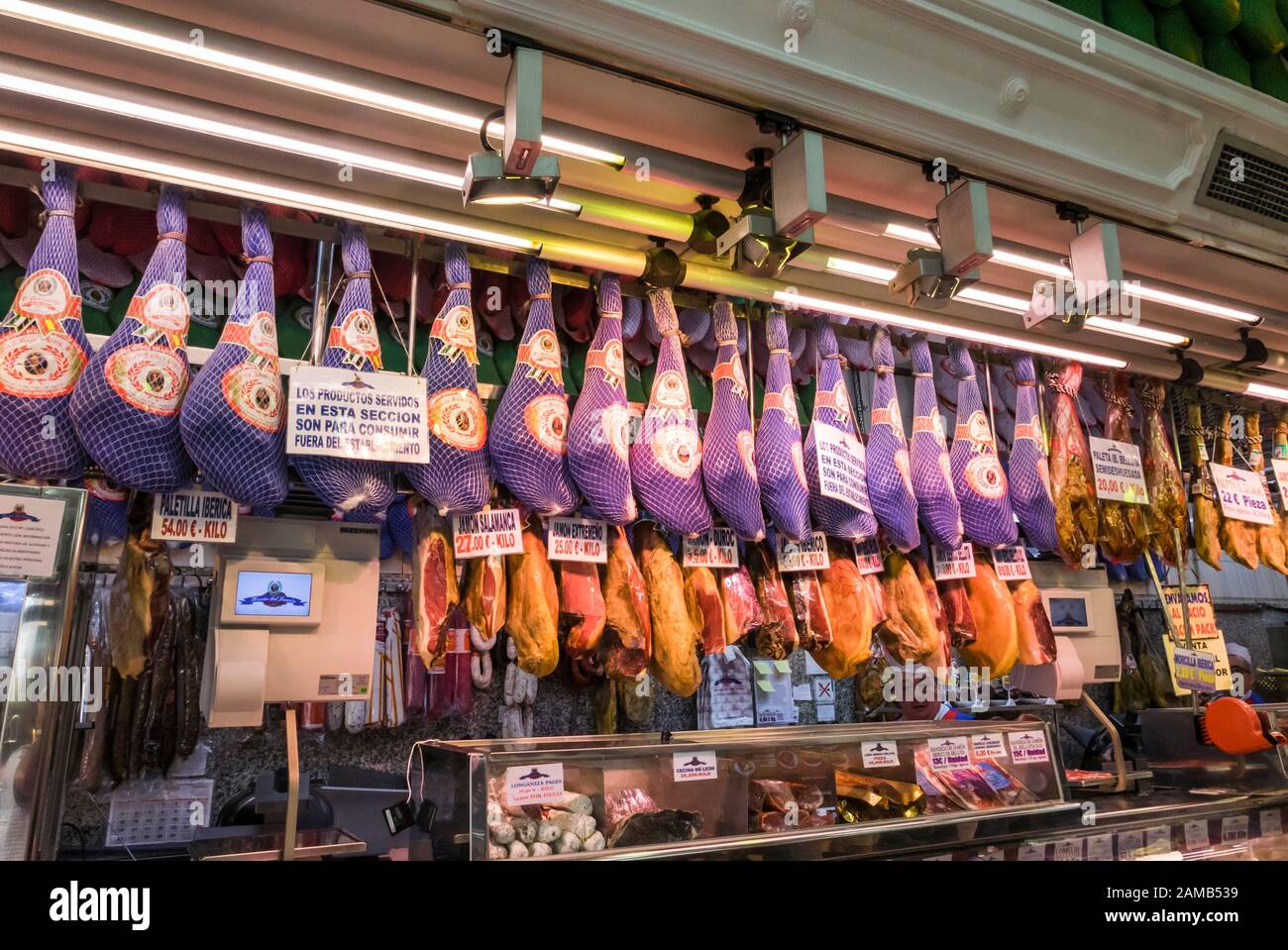 Spanish hams ( Jamon Iberico ) hanging in a charcuterie i Madrid, Spain Stock Photo
