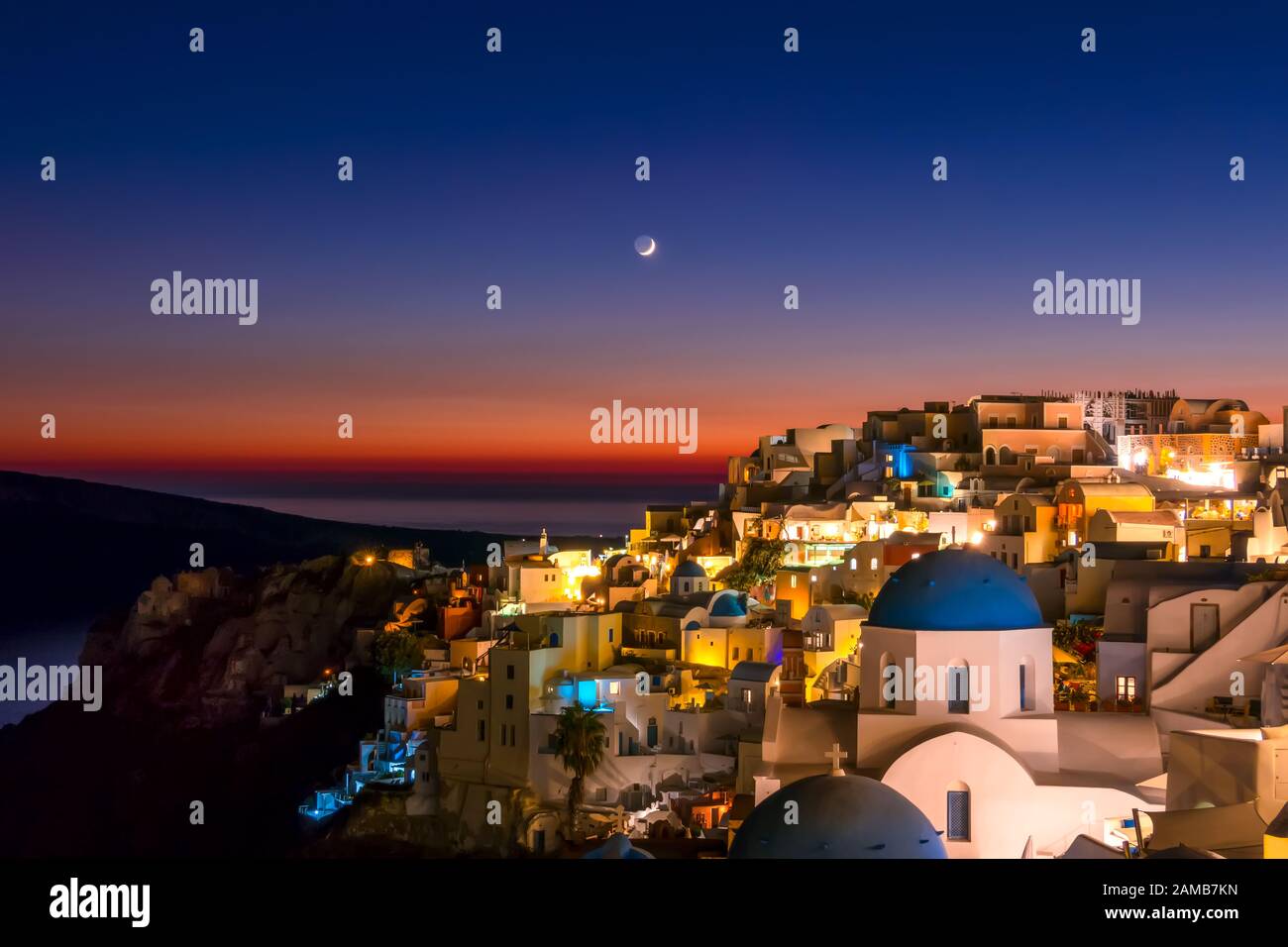 Greece. Thira Island. Nidght roofs of Oia at the late evening and moon Stock Photo