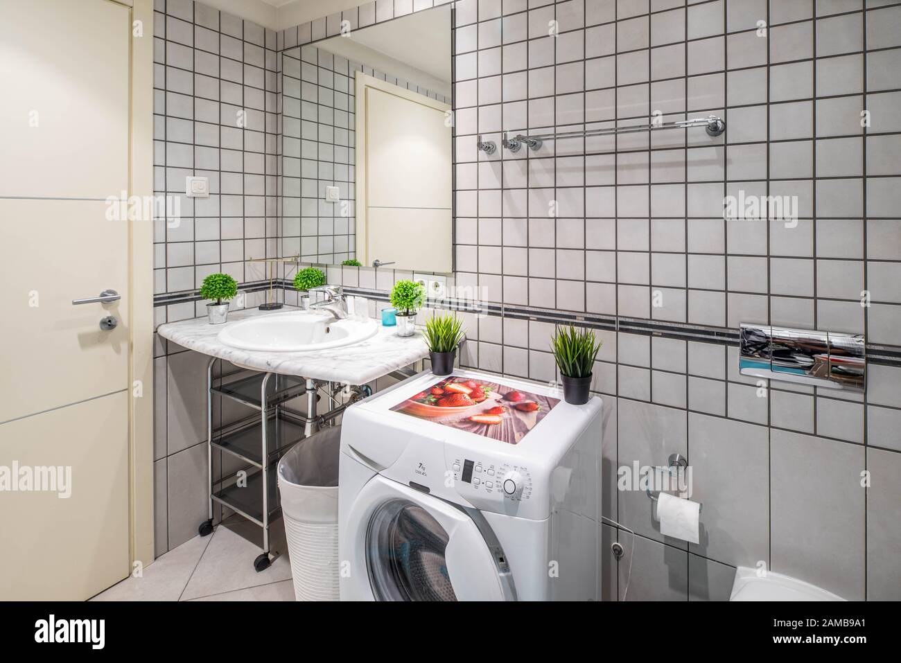 Modern interior of bathroom. Washing machine. Marble surface. White sink Stock Photo Alamy