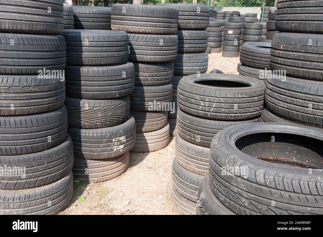 The piles of used tires lie on the square. Black rubber tire, part of