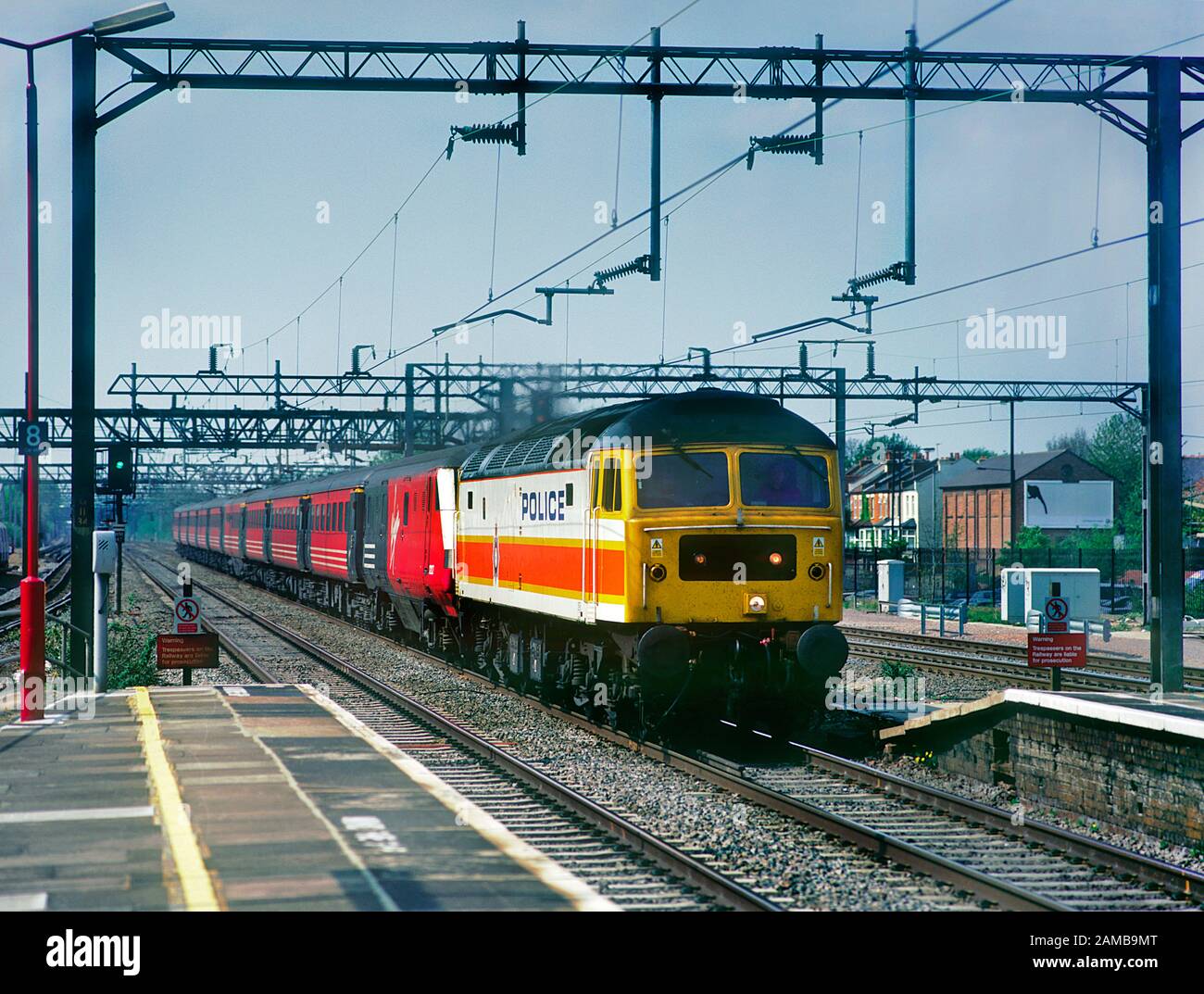 A class 47 diesel locomotive number 47829 painted in a unique Police livery and deputising for a failed electric locomotive working a Virgin West Coast service at Harrow and Wealdstone. Stock Photo