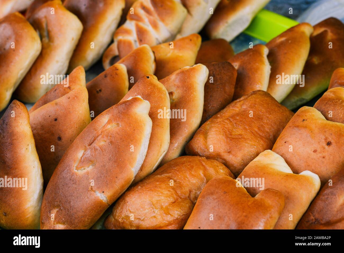 Traditional Russian baked pies closeup. Fresh mince pies Stock Photo