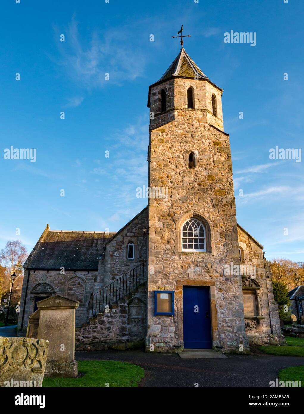 Pencaitland Parish Church (Church of Scotland) 17th century church with sunny sky and old graves, East Lothian, Scotland, UK Stock Photo
