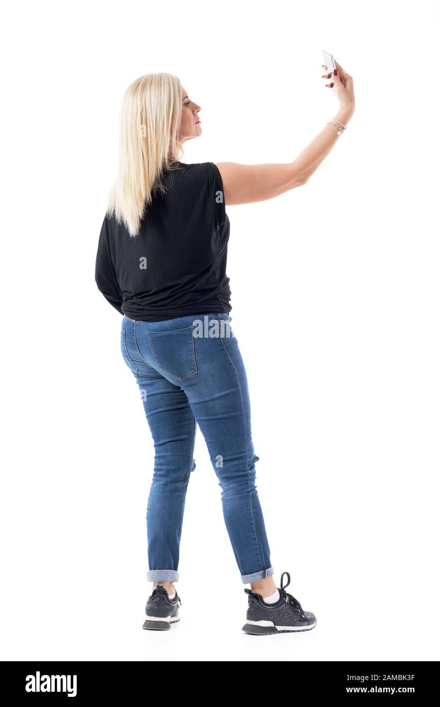 Attractive woman standing and looking up. Side view. Isolated on white  Stock Photo - Alamy