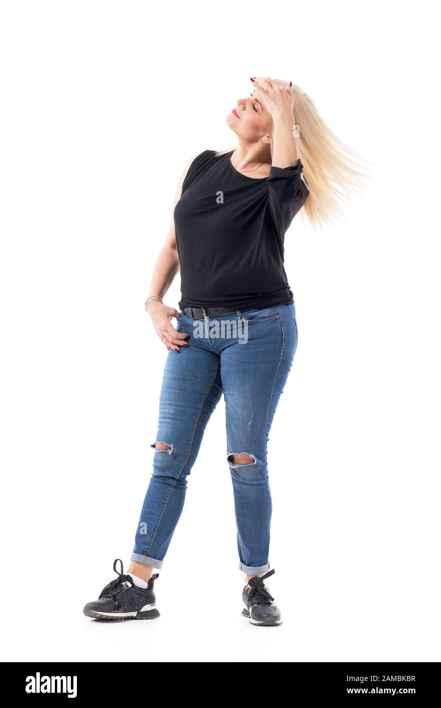 Blonde casual middle age woman tossing her healthy blonde hair. Full body length isolated on white background. Stock Photo