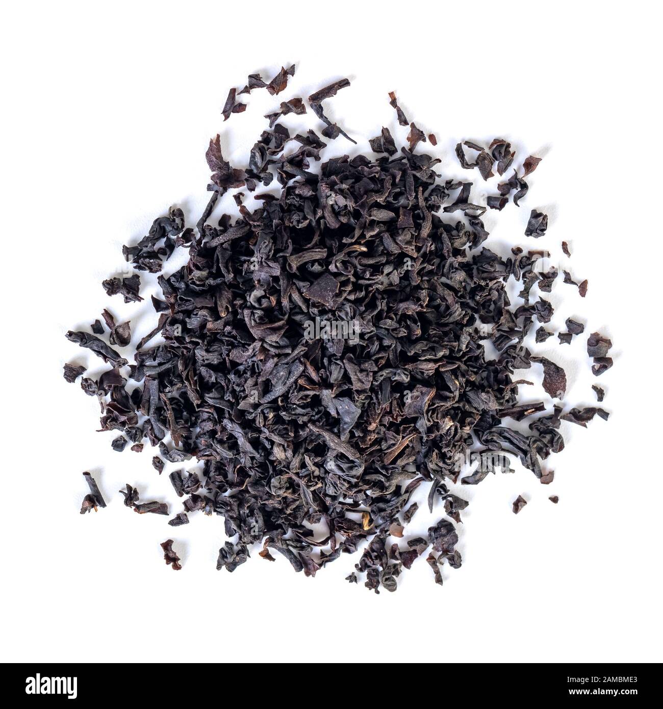 Top view of dried black tea leaves on a white background Stock Photo