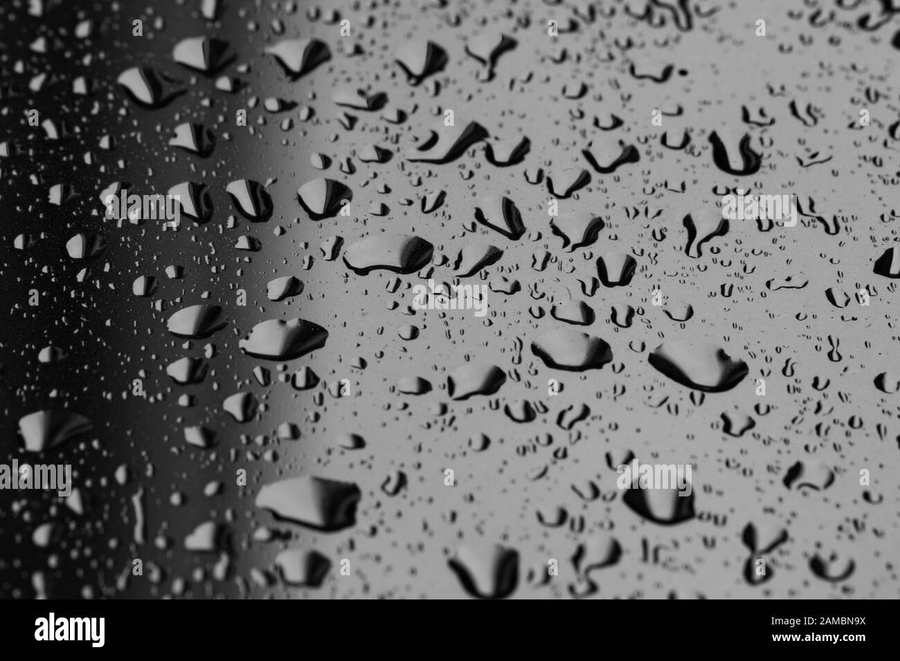 Large water droplets and condensation on backlit glass pane Stock Photo