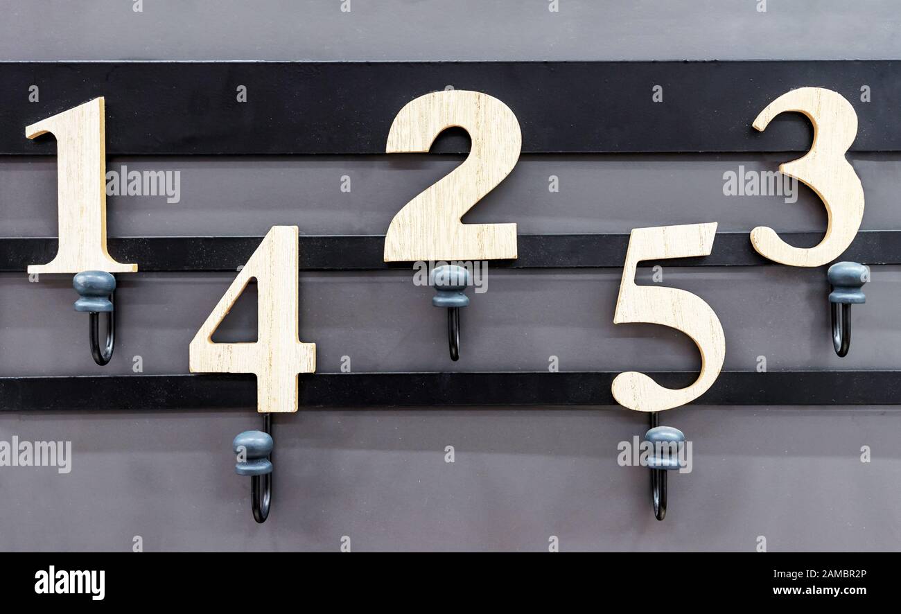 Metal hanger with hooks and wooden numbers Stock Photo Alamy