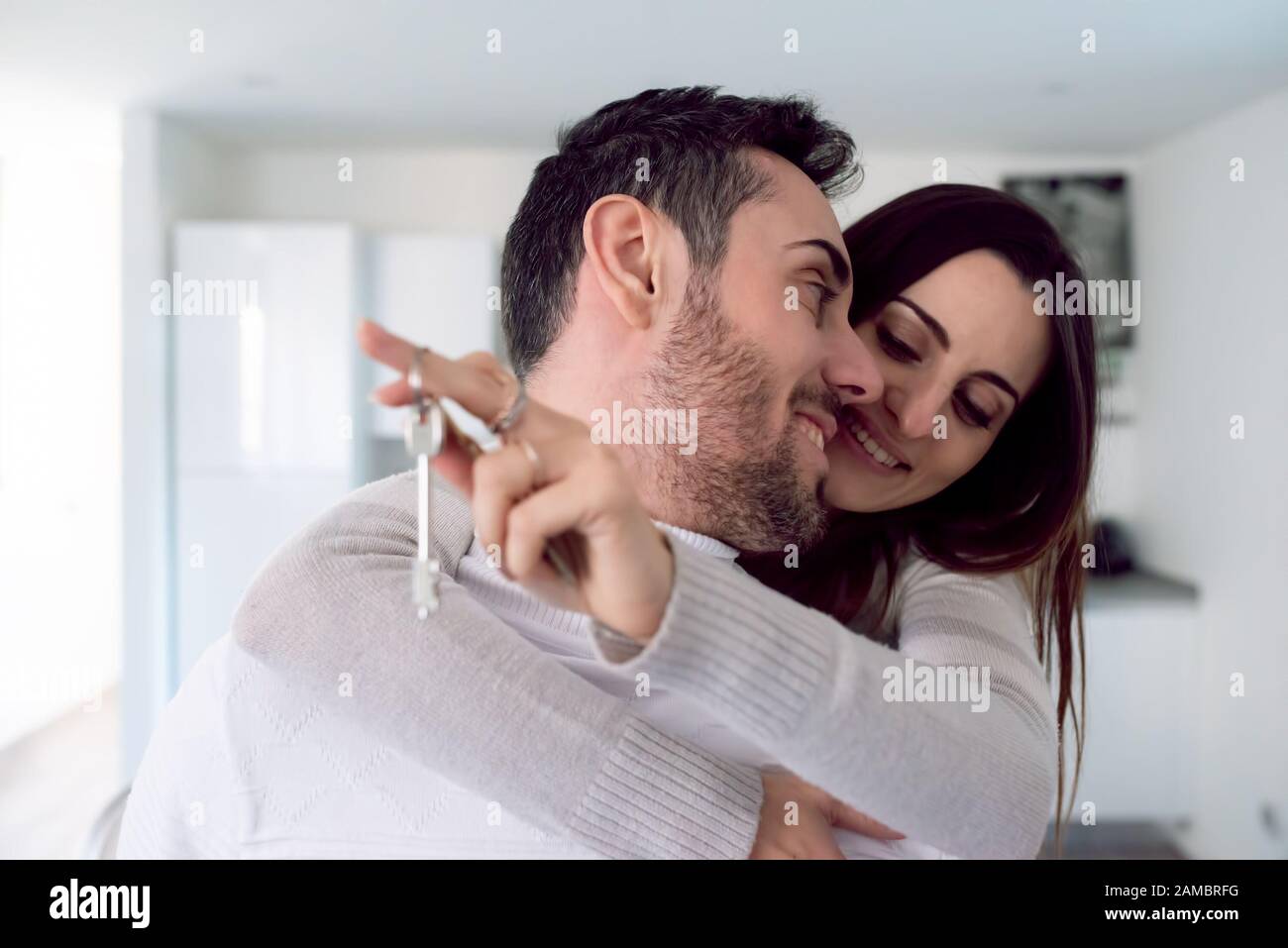 Couple showing the keys of their new house Stock Photo - Alamy
