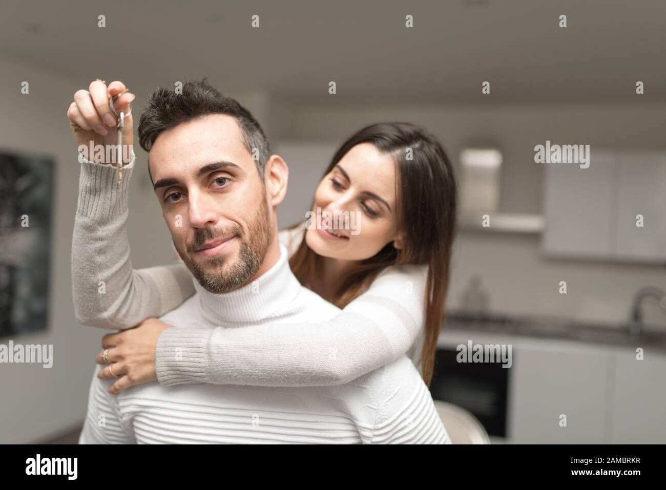 Happy couple showing the keys of their new house Stock Photo - Alamy