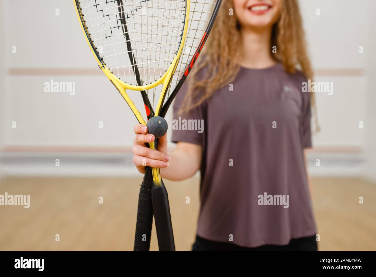 Female person shows squash racket and ball Stock Photo Alamy