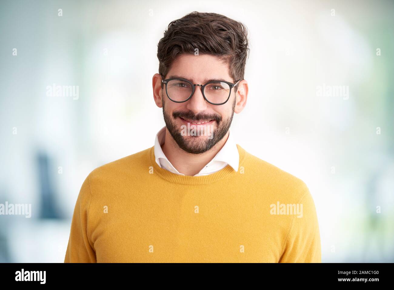 Portrait of smiling young man wearing glasses hi-res stock photography ...