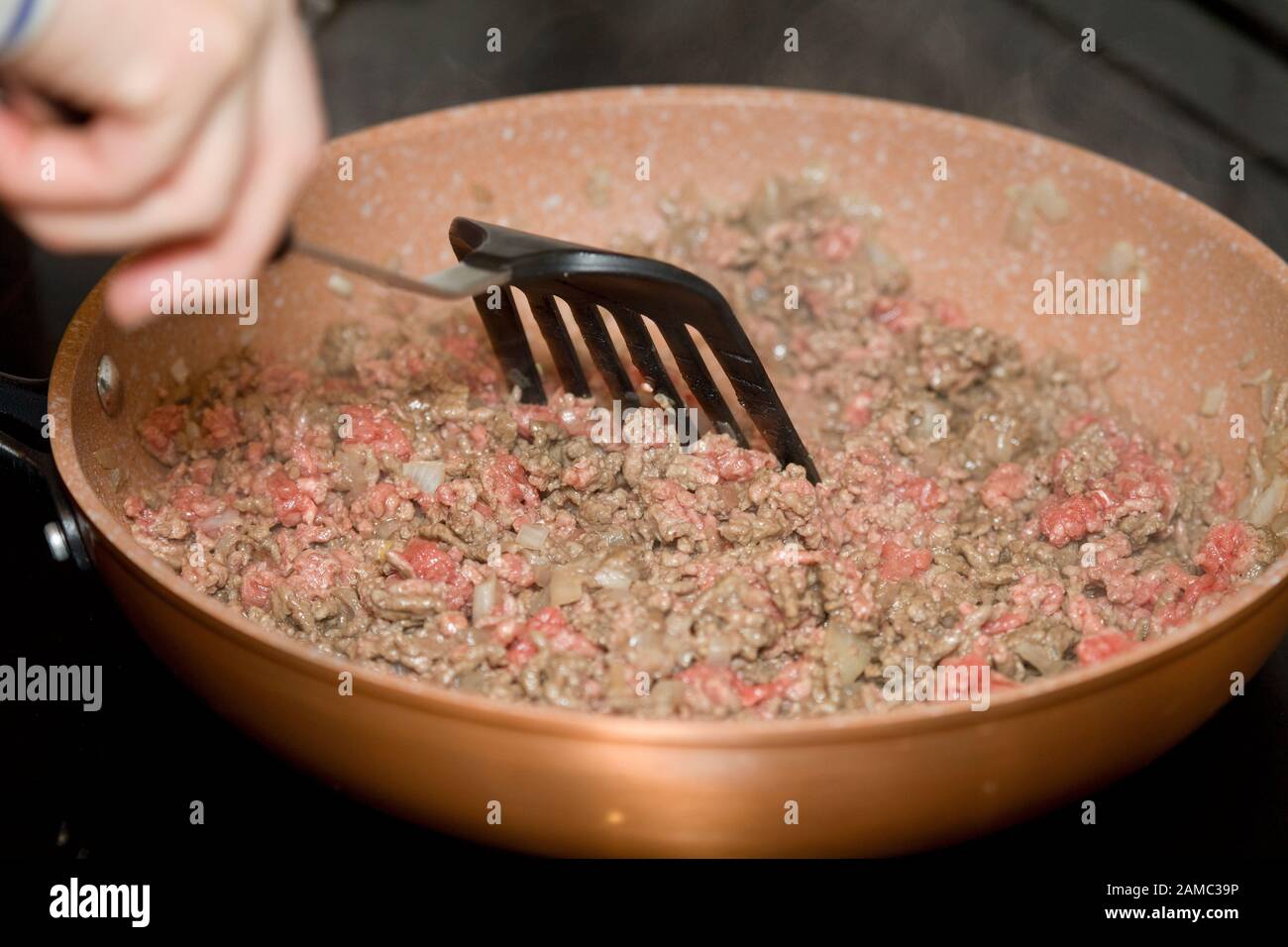 Browning ground beef mince meat with onions Stock Photo