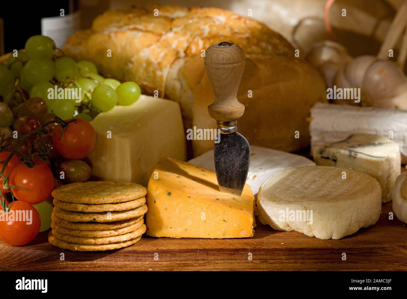 Cheese board with a selection of cheeses and fruits Stock Photo