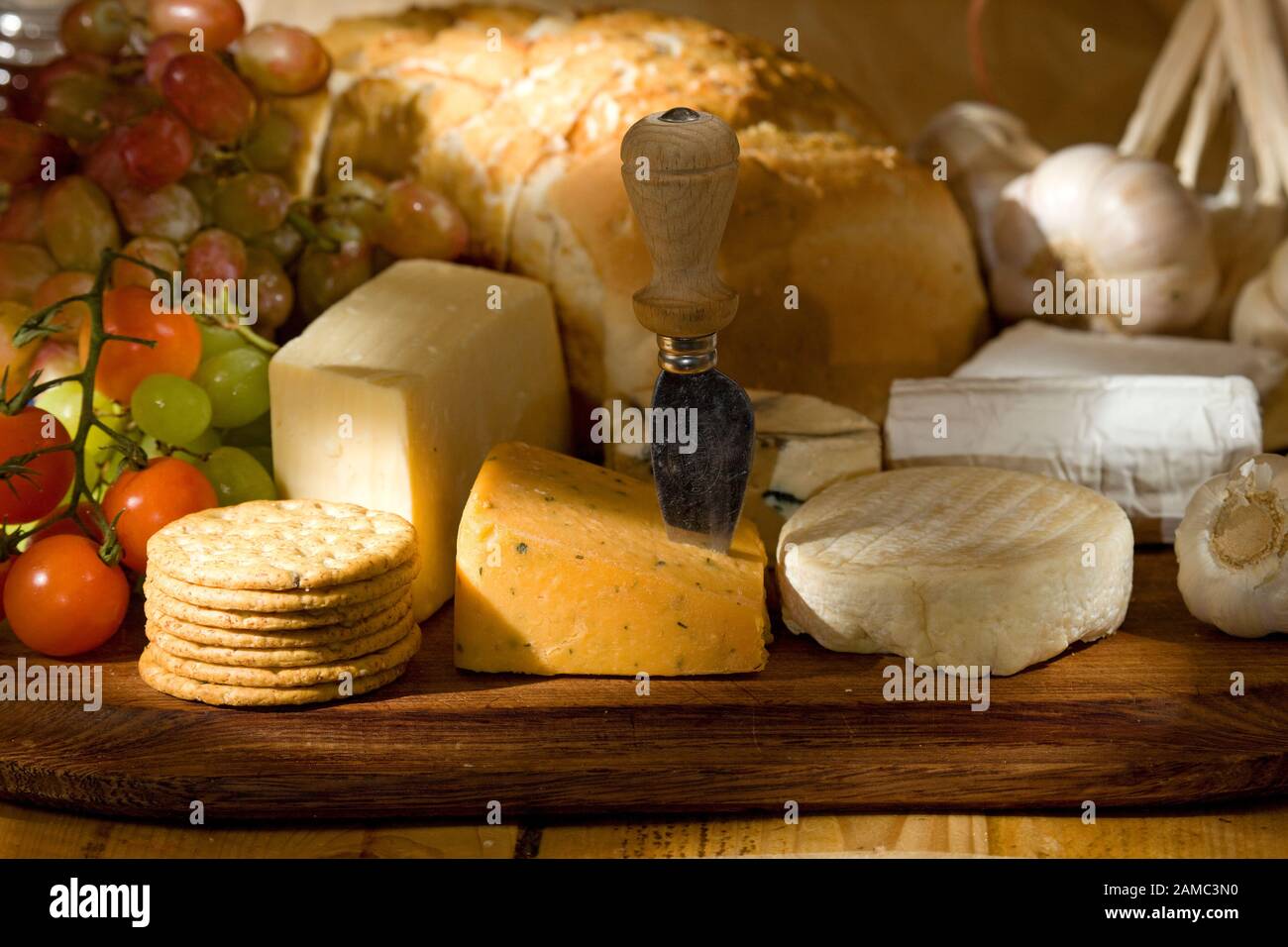 Selection of cheeses, bread, fruits and vegetables Stock Photo