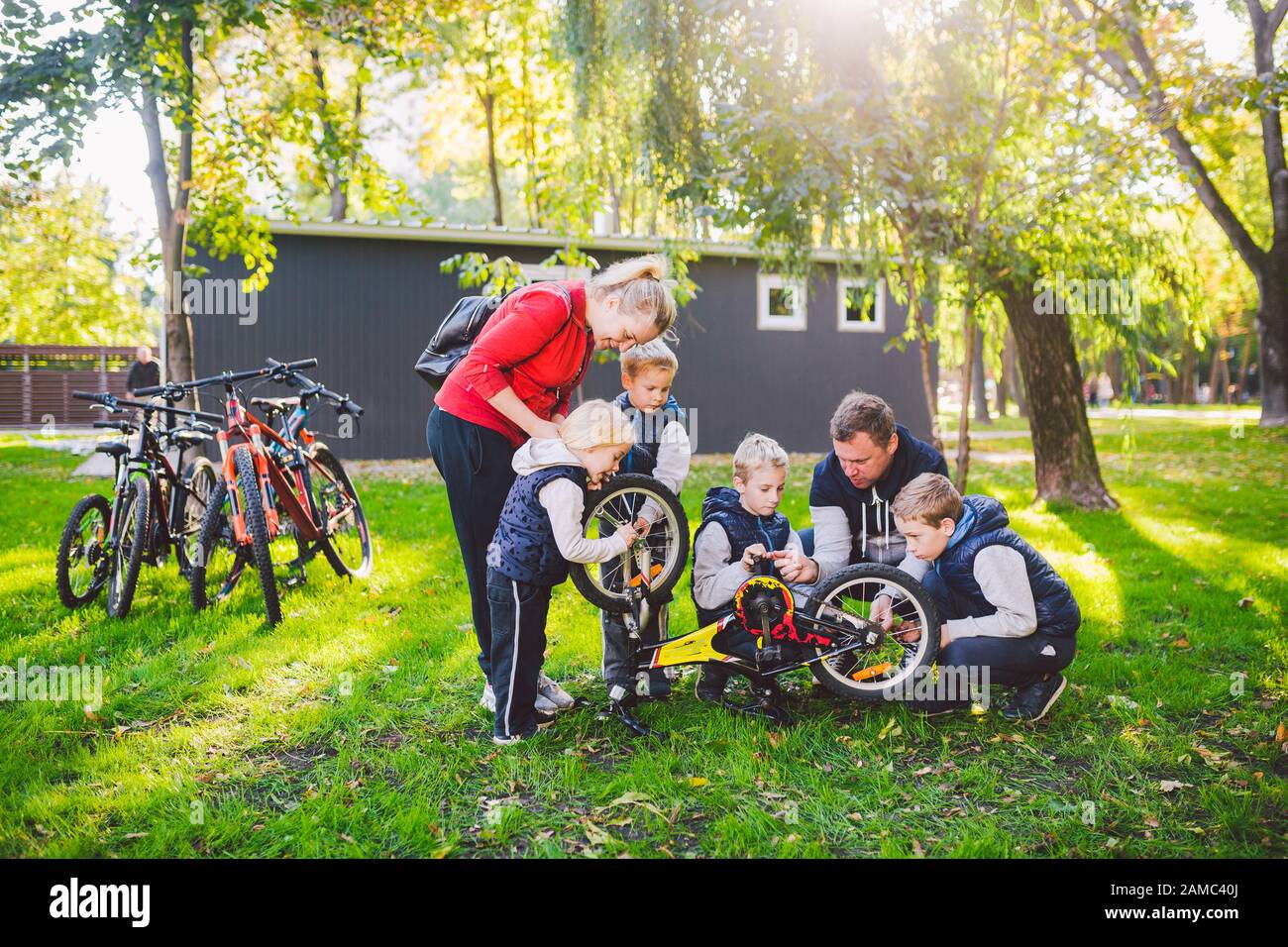 Children Fixing Problems The theme of teamwork and friendly family. Outdoor activities. Parents ...