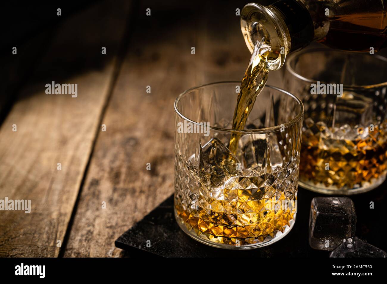 Whiskey in glasses on wood background Stock Photo