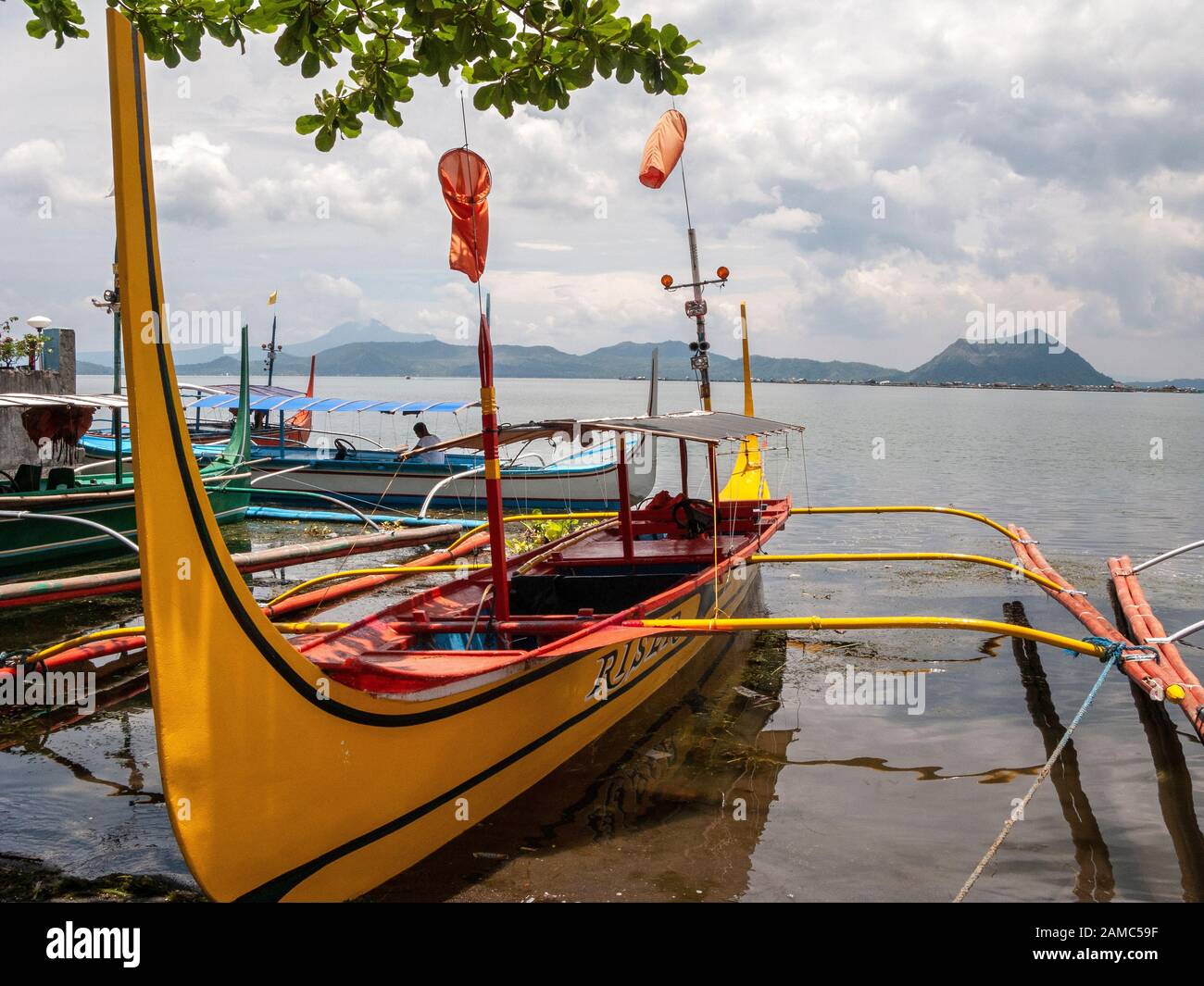 At Taal lake nearTagaytay, south of Manila. Taal volcano and traditional outrigger boats. Stock Photo