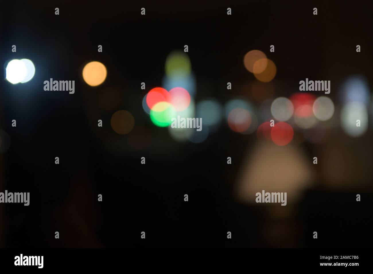 Multi-colored, blurry bokeh balls at night Stock Photo