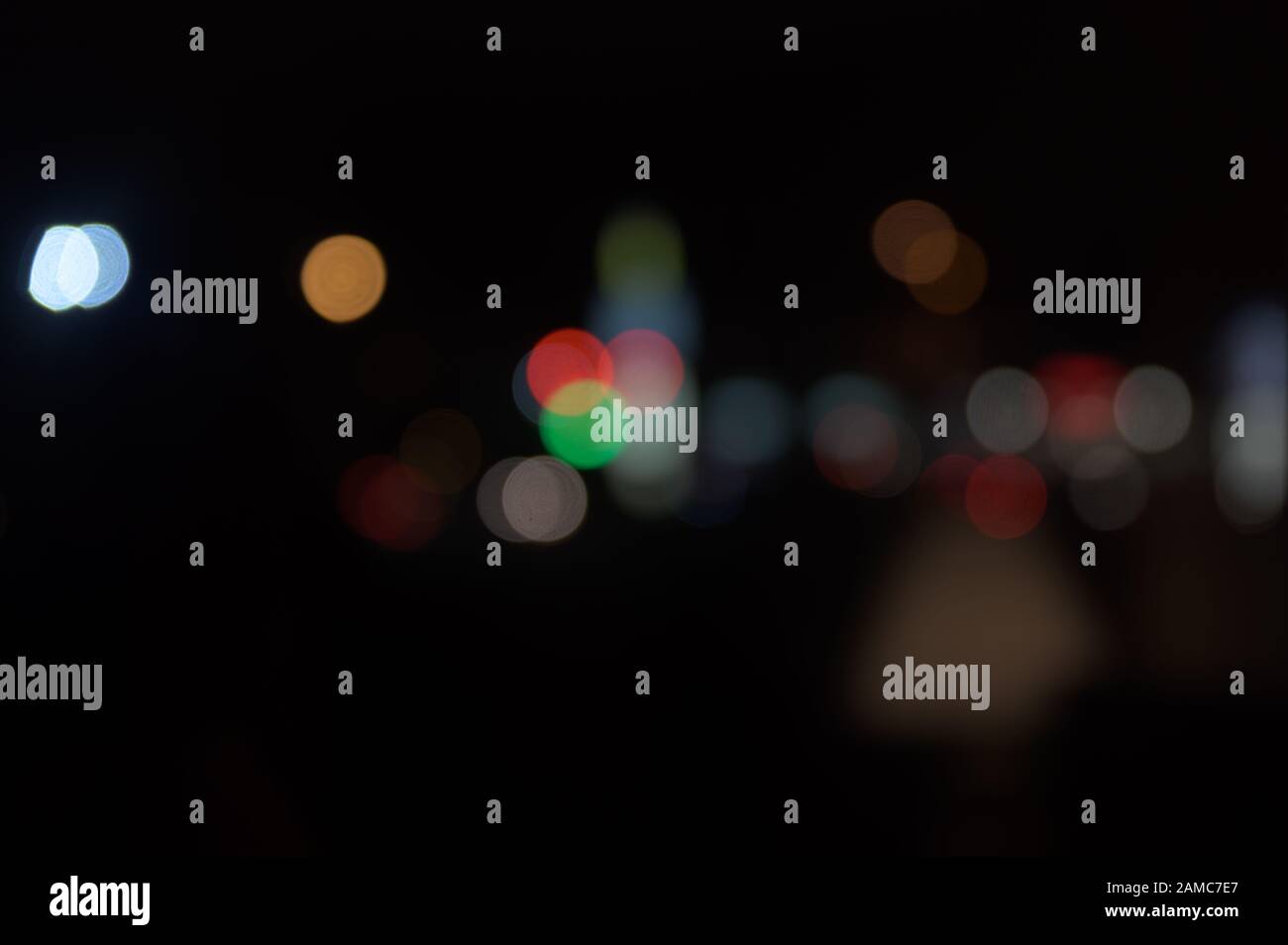 Multi-colored, blurry bokeh balls at night Stock Photo