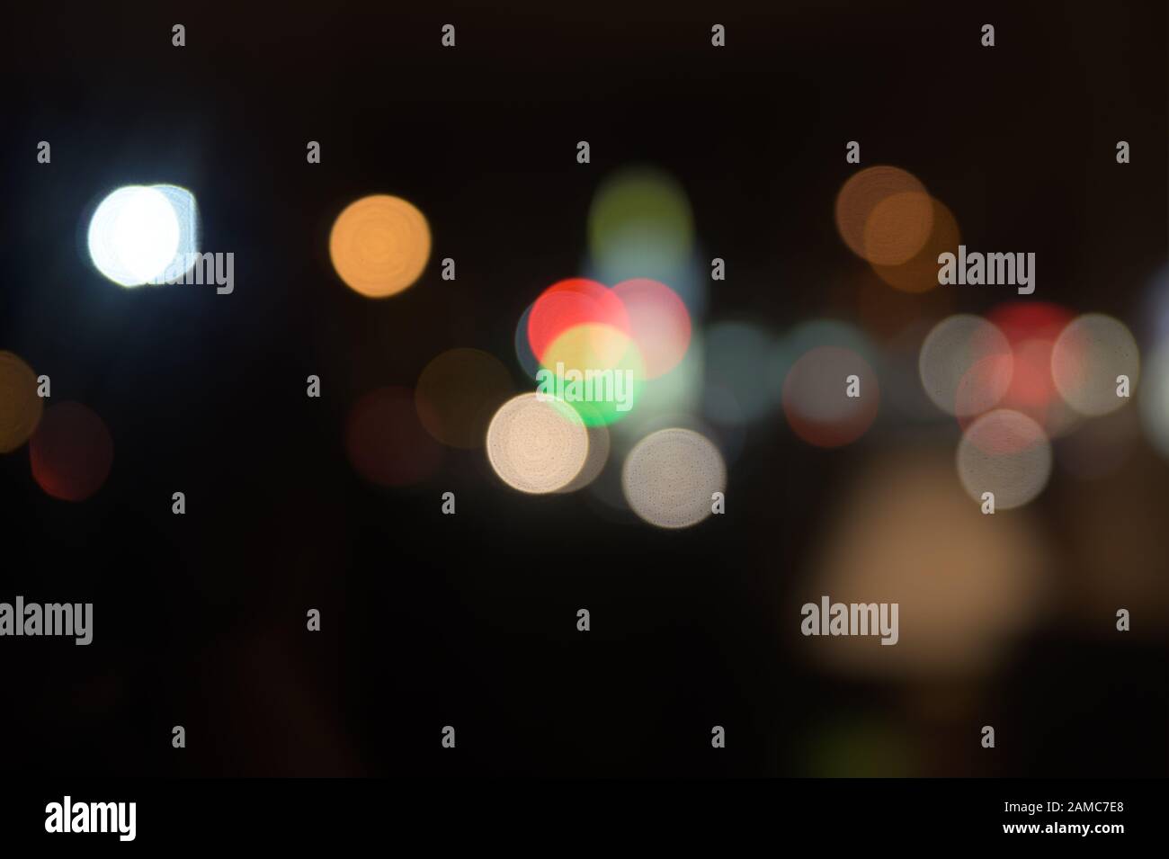 Multi-colored, blurry bokeh balls at night Stock Photo