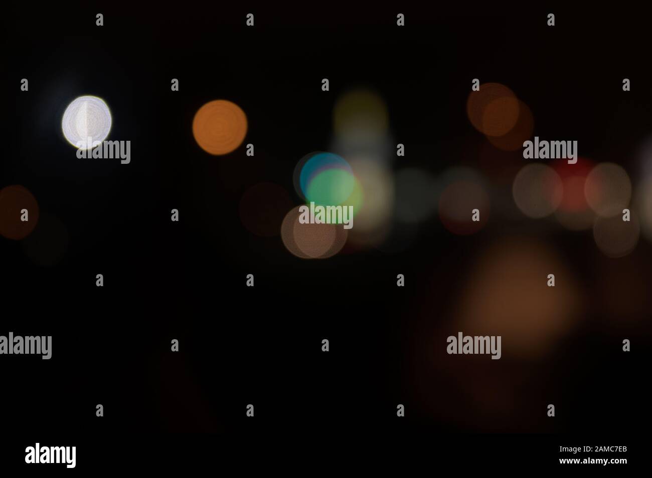 Multi-colored, blurry bokeh balls at night Stock Photo