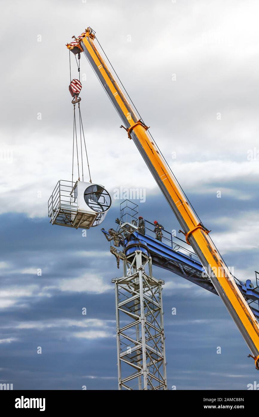 Assembly of a construction crane in rainy day Stock Photo