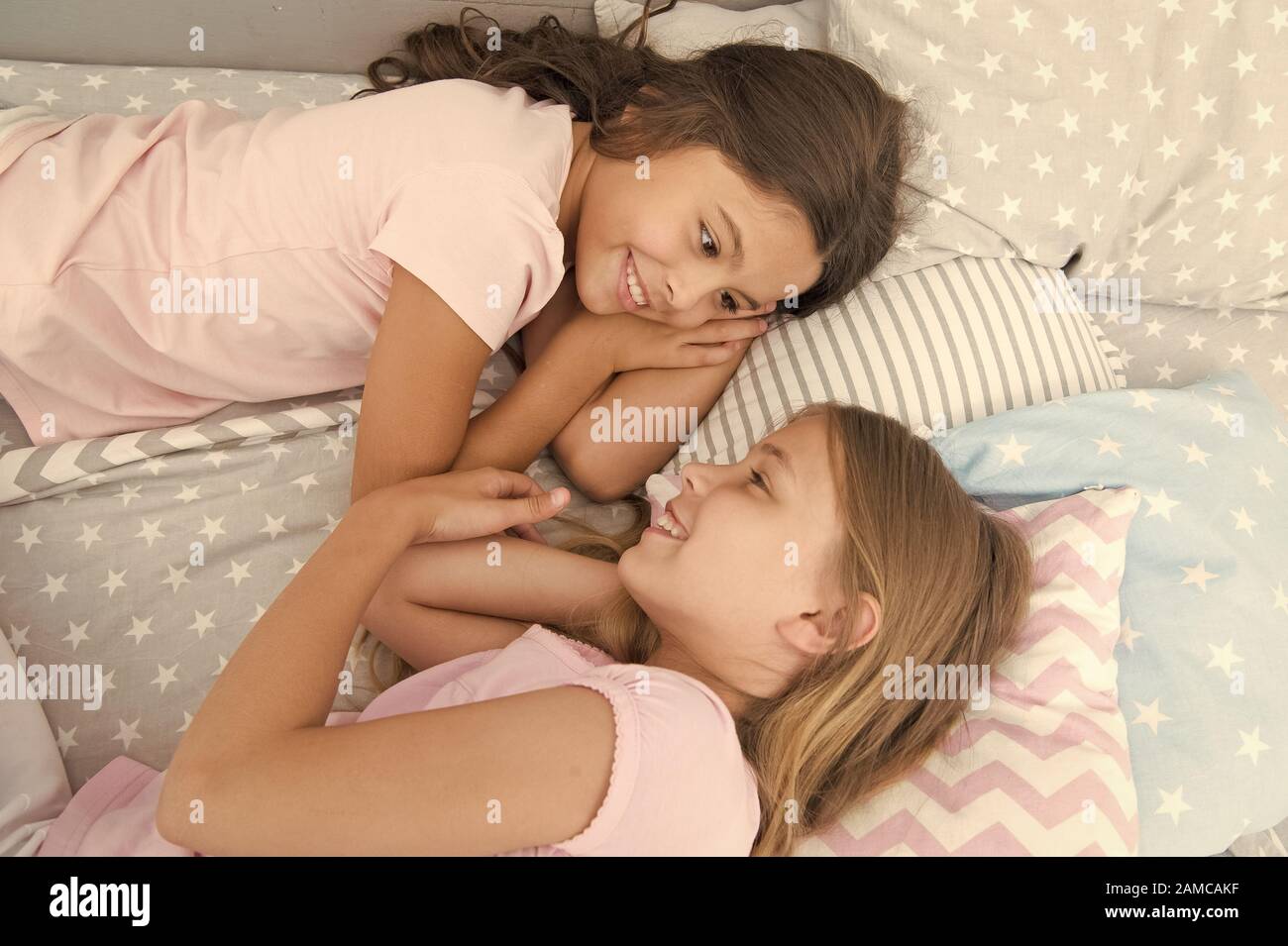 One of the luckiest things is to have a happy childhood. Adorable little children having afternoon nap in bedroom. Enjoying happy childhood. Childhood years. Childhood and girlhood. Stock Photo