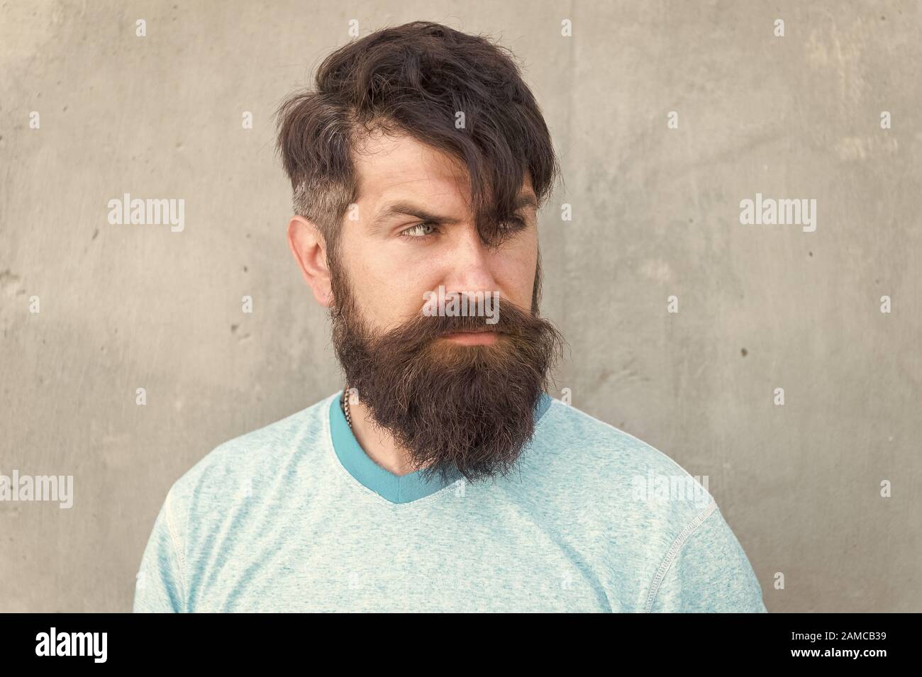 Hipster lifestyle. Brutal handsome mature hipster man. Bearded man trendy  style. Beard and mustache grooming. Long hair. Cut bangs. Cool hipster with  beard need haircut. Barber salon and facial care Stock Photo -