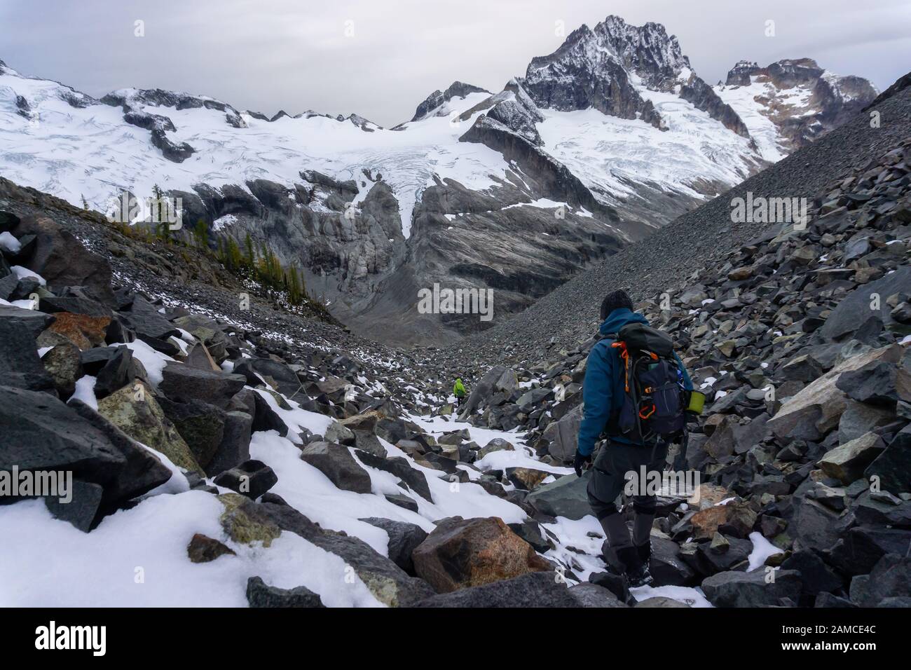 Adventurous Female Hiker on top of a mountain Stock Photo