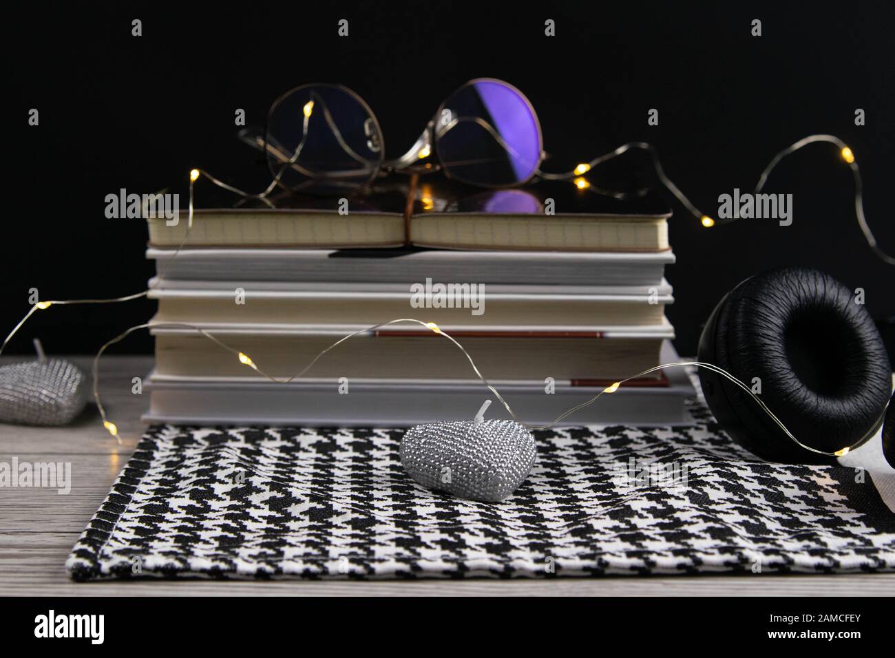 Stack of books and notepads on which are glasses and on the side of headphones. nice background. top views Stock Photo
