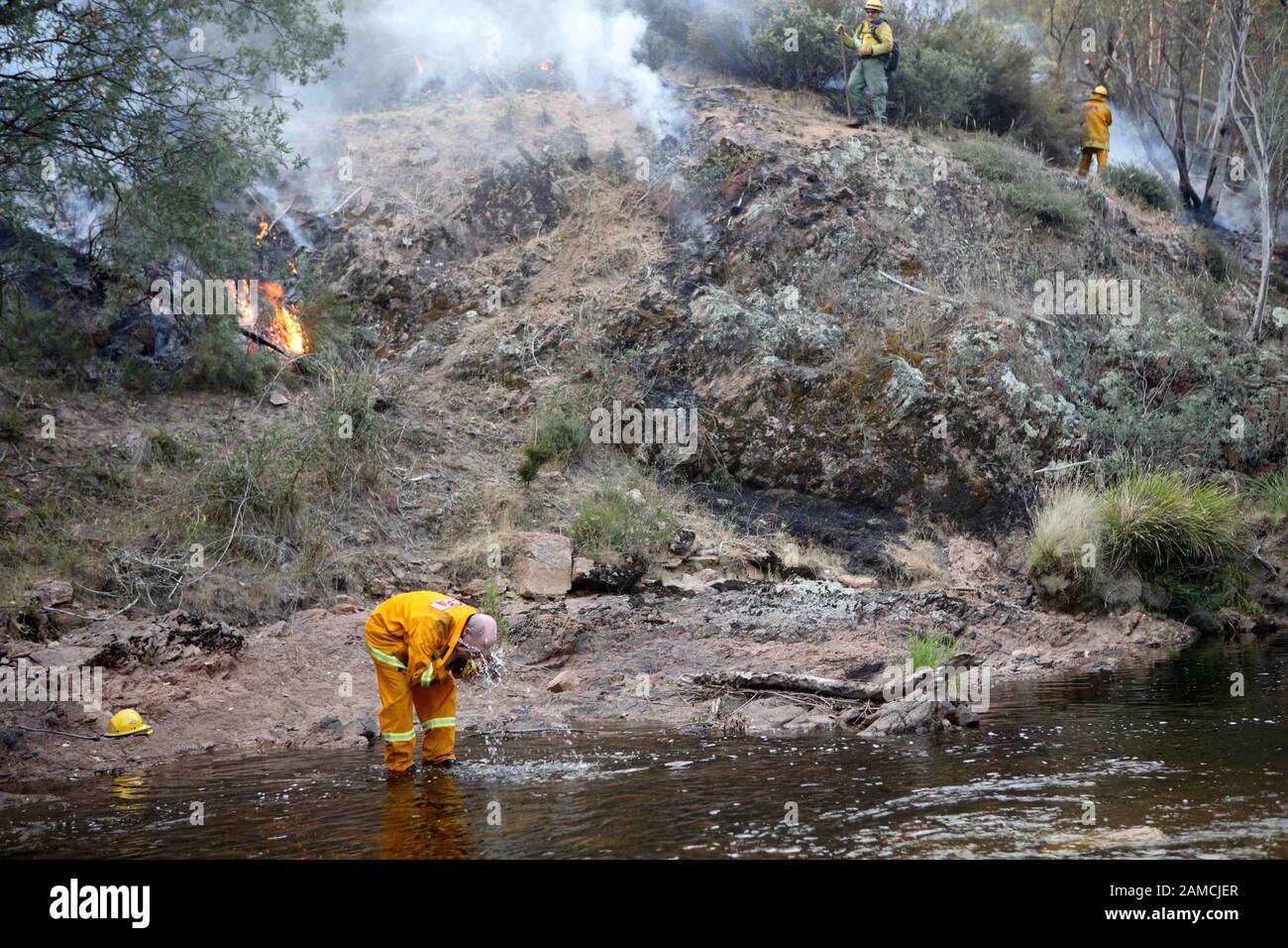 Victoria, Australia. 12th Jan, 2020. Fire fighter Roger Walkvin washes his face with water from a stream as a joint Australian and U.S. strike team blackline an area in order to control a bushfire and protect nearby structures, in Alpine National Park near Omeo. The Australian firefighters are with Country Fire Authority Australia and the U.S. team is the third rotation in for 28 days and they come from five different U.S. agencies. Credit: ZUMA Press, Inc./Alamy Live News Stock Photo